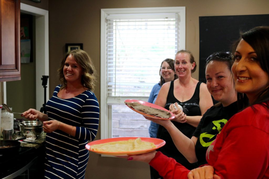 THM group meetings The group gathers around as Kaylee shows everyone how to cook the Wonder Wraps